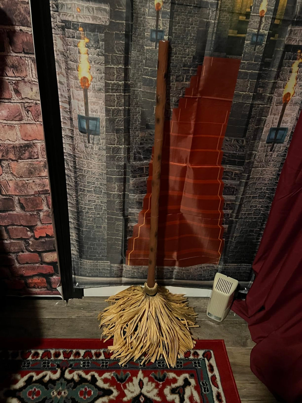 Broomy witch broom standing by a decorated front window