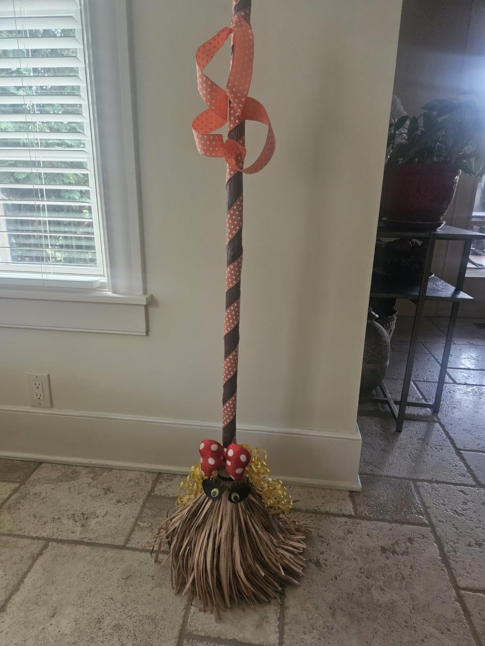 Broomy witch broom decorated with a bow and ribbon